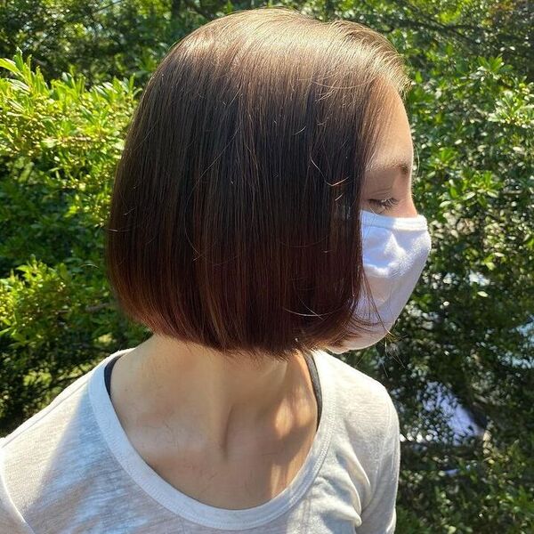 Rounded Bob Hairstyles for Round Faces- a woman wearing a white face mask and a white shirt