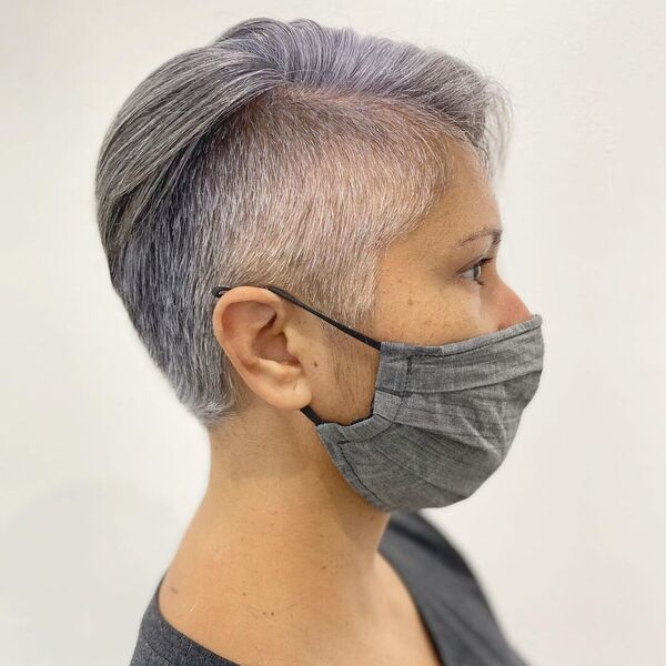 Salt and Pepper Undercut Hair- a woman wearing a gray face mask