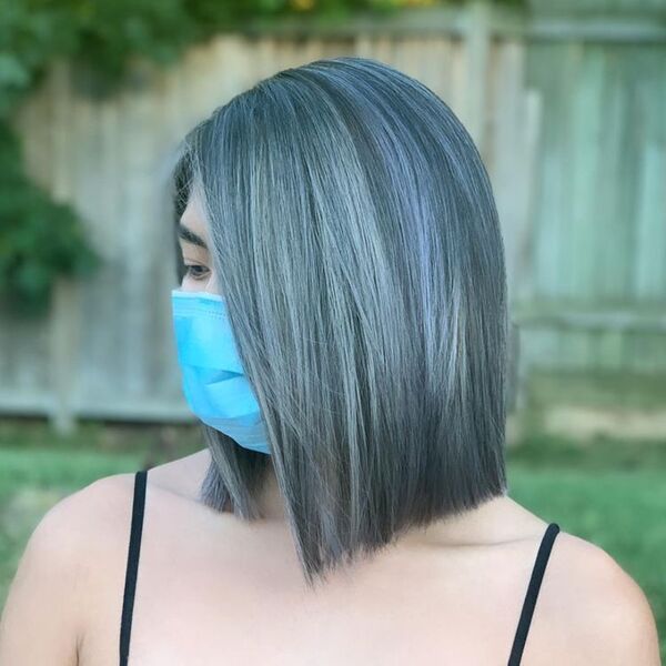Silver Gray Medium Hairstyle - a woman wearing a face mask