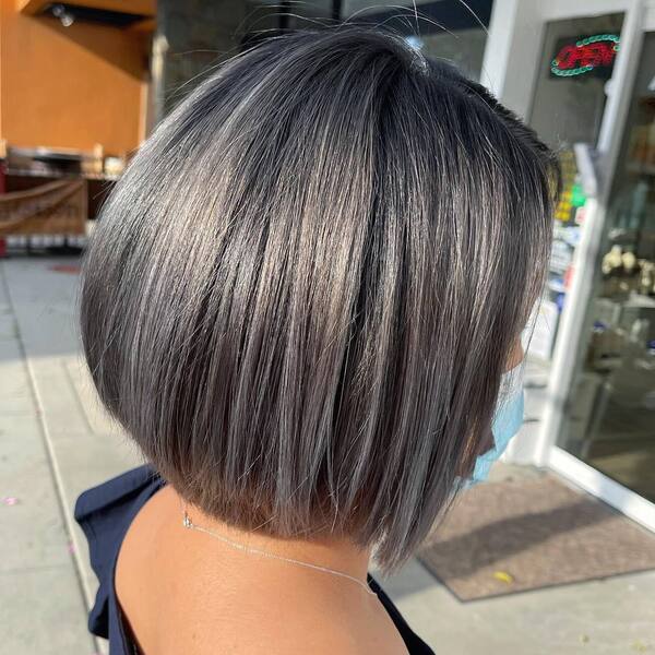 Stainless Steel Gray Hair Colored Bob- a woman wearing a black off-shoulder blouse