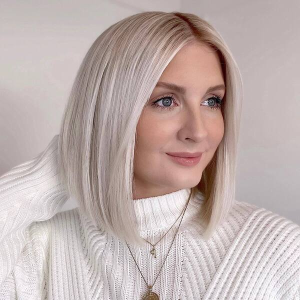 Straight Blonde Bob Hair- a woman wearing a white sweater