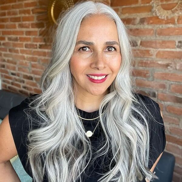 Trendsetter for Natural Gray Hair Color- a woman wearing a black dress