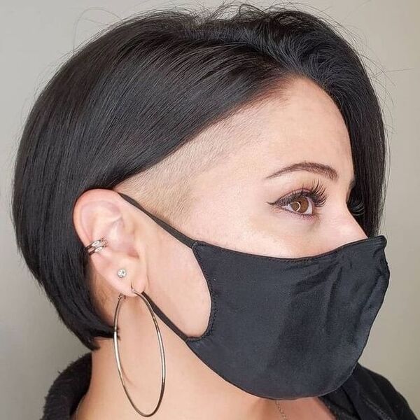 Undercuts for Round Faces- a woman wearing a black face mask